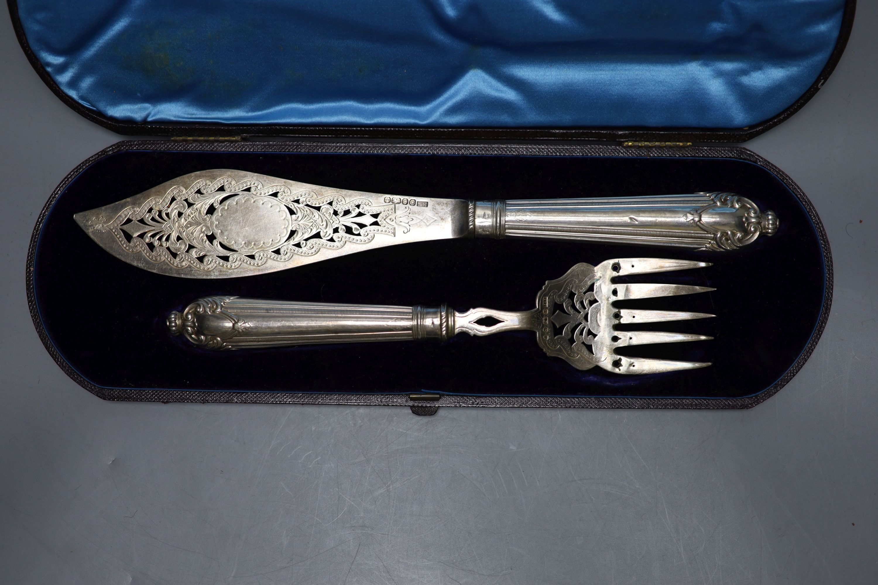 A cased pair of Victorian silver fish servers, Harrison Brothers, Sheffield, 1874, knife 31.5cm.